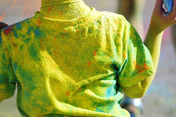 dyed clothes on people at the festival of multicolored paints