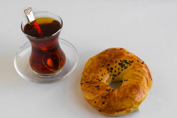 Close-up taken of homemade Traditional Turkish black cumin pastry,acma with tea on white background