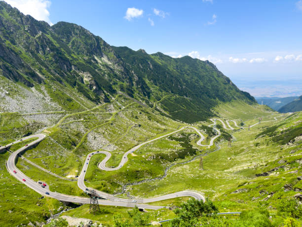 istock A winding road cuts through a lush green mountain valley 2156666721