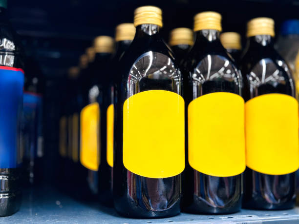 Virgin olive oil bottles with yellow labels displayed on a store shelf.