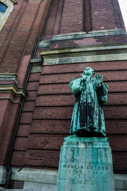 statue of martin luther in front of the cathedral of hamburg in germany
