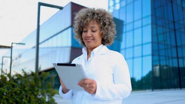 istock Mature doctor taking a break in front of her clinic 2156667833