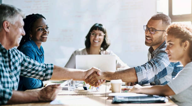 istock Group, handshake and business people in meeting, teamwork and planning for project, feedback and agreement. Staff, employees or negotiation for company merger, cooperation and collaboration in office 2156667930