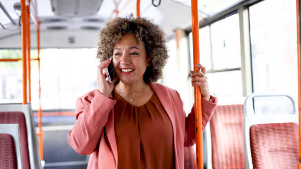 istock Businesswoman telephoning during a bus ride 2156668032