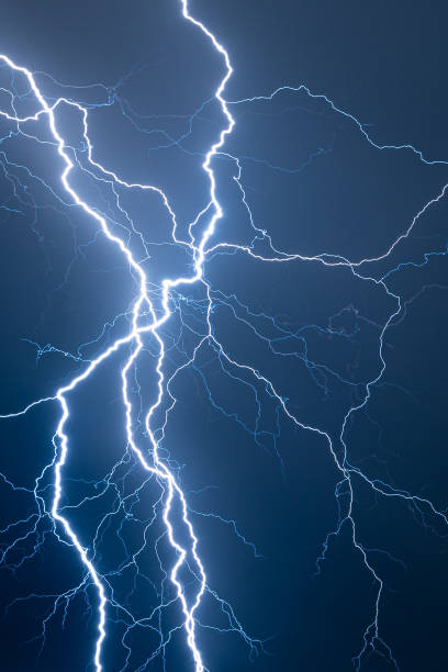 istock Multi branched lightning bolts against a dark blue background 2156669480