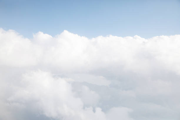 istock Sunrise above textured clouds from airplane window 2156669636