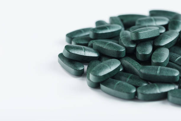Spirulina in pills isolated on white background