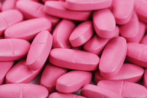 istock Pink pills with multivitamins in full screen as a background. 2156671573
