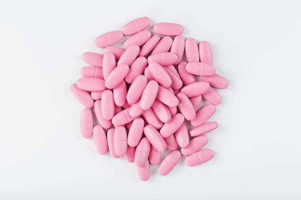 istock Pink vitamin pills for women on a white background. 2156671723