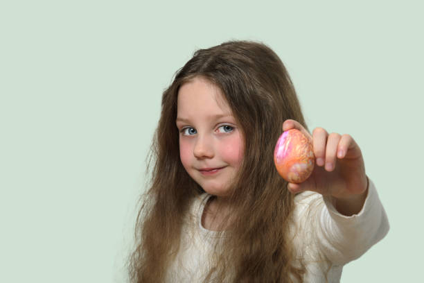 istock A little girl shows an Easter egg. 2156673790