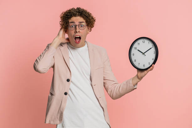 istock Caucasian man with anxiety checking time on clock, running late to work, being in delay, deadline 2156674876