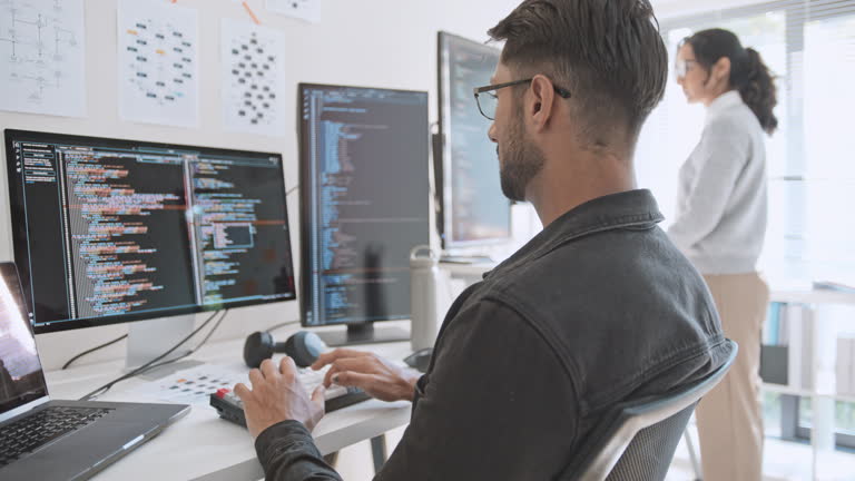 Hispanic Latin American couple, software engineer developer use computer, work on program coding together at home office. Programming language development technology, freelance job concept