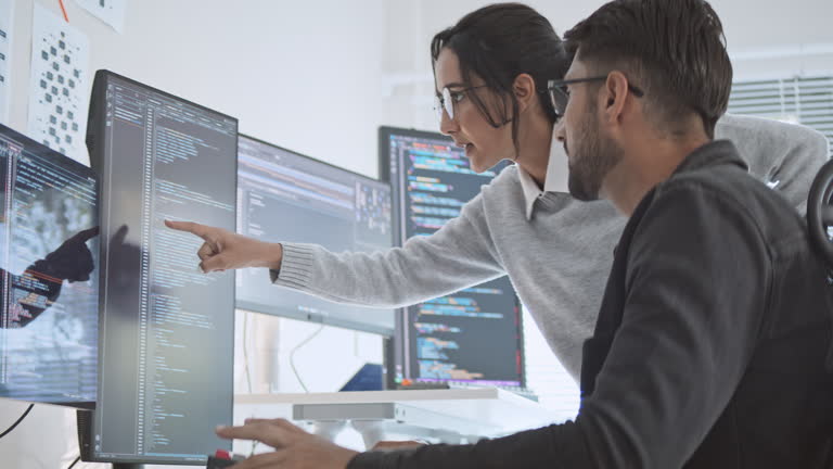 Hispanic Latin American couple, software engineer developer use computer, work on program coding together at home office. Programming language development technology, freelance job concept