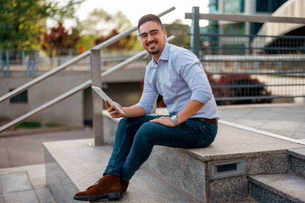 istock Happy businessman outdoors with a tablet 2156676560