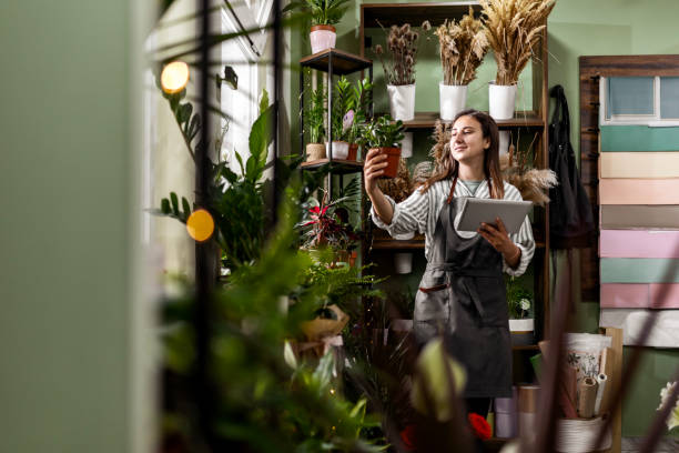 istock Woman Using Tablet in Flower Shop 2156676574