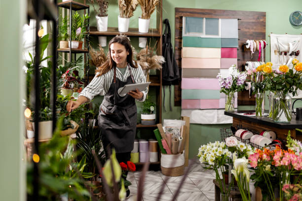 Woman Managing Flower Shop with Tablet
