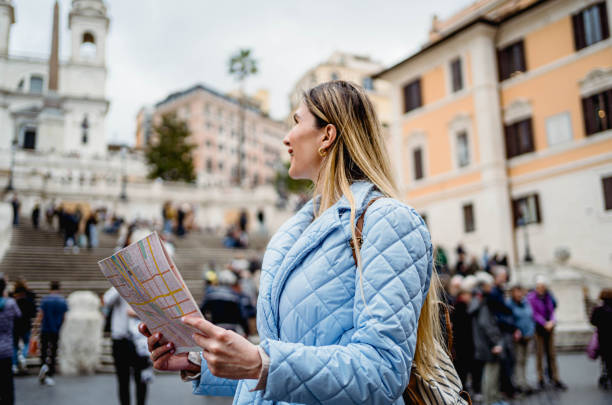 istock Woman tourist using a map in front of Spanish steps in Rome 2156676793