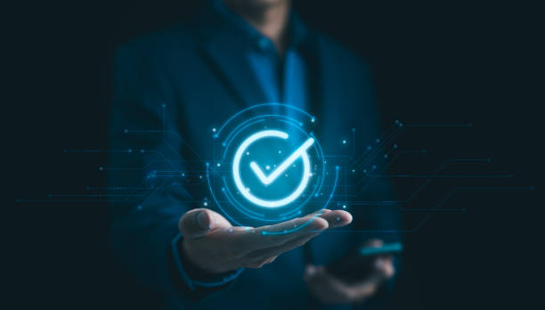 istock Businessman Holding Digital Check Mark Icon. standard quality control certification assurance guarantee for automation process. Quality management, Quality Assurance, Quality Control, Standardization, 2156677082