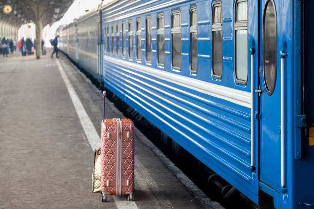 istock Modern suitcase stands on platform in front of carriage 2156677168