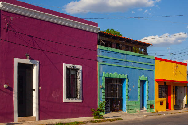 istock Small pastel colored colonial house with a washed out facade 2156677245