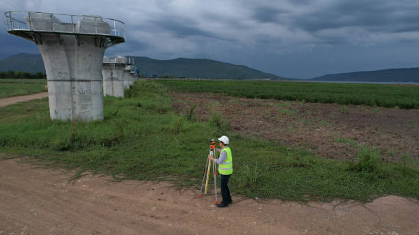 High-angle view of Civil or construction engineer using a survey camera or an engineer with an auto-level camera  at construction site