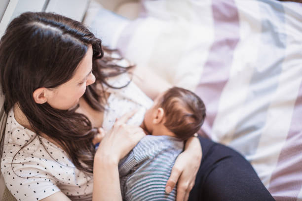 istock Mother Breastfeeding Baby in Cozy Morning Light 2156680171