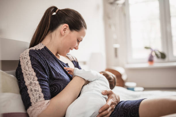 istock Mother Breastfeeding Baby at Home 2156680180