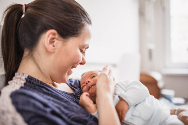 istock Mother Smiling at Newborn 2156680196