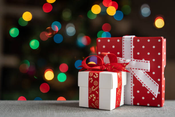 istock Two gifts in front of christmas tree 2156682279