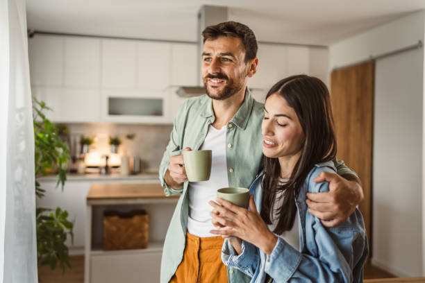 istock Boyfriend and girlfriend enjoy their first morning coffee at kitchen 2156685146
