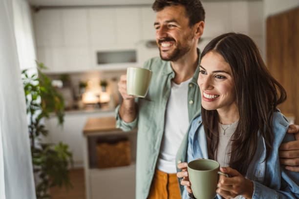 istock Boyfriend and girlfriend enjoy their first morning coffee at kitchen 2156685241
