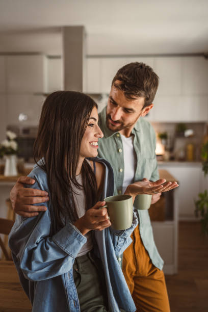 istock Boyfriend and girlfriend enjoy their first morning coffee at kitchen 2156685447