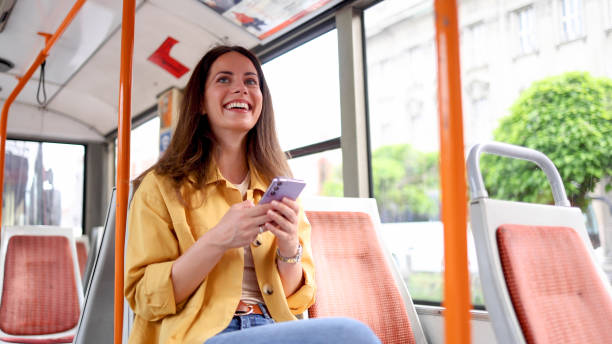 istock Young woman using smartphone in the city bus 2156687273