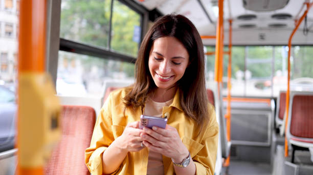 istock Happy woman surfing the net while riding in a bus 2156687369