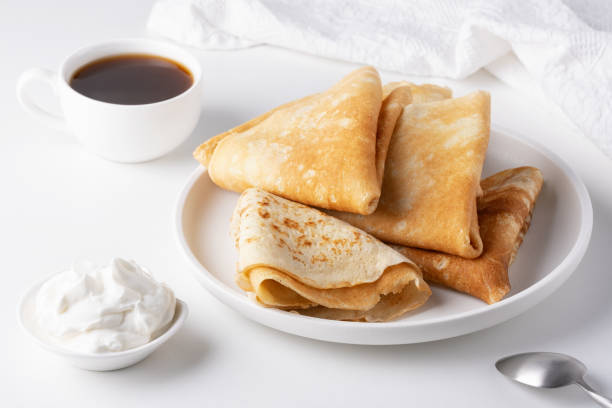istock Pancakes with sour cream on a white table 2156689153
