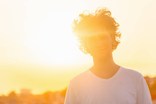 Portrait of a young Caucasian man, on the beach during majestic sunset