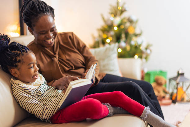 istock Joyful Storytime by the Christmas Tree 2156692543