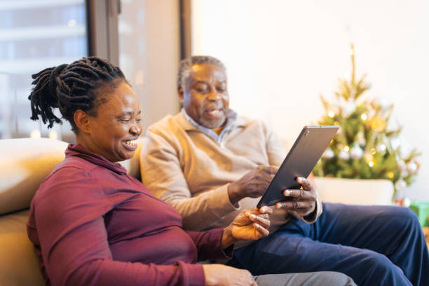 istock Senior Couple Relaxing with Tablet Indoors 2156692556