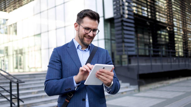 istock Young businessman using tablet in front of his company 2156693045