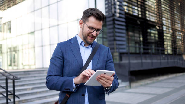 istock Young businessman using tablet in front of his company 2156693048