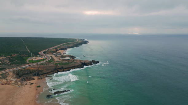 istock Blue ocean meeting rocky coastline under evening sky drone shot. Tranquil waves 2156693193