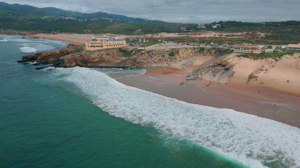 istock Rocky cliffs bordering beach washed by beautiful sea aerial view. Ocean waves 2156694718