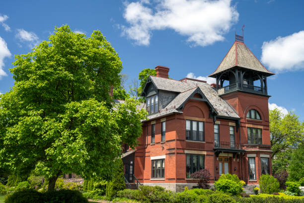 Jim Thorpe, Pennsylvania, United States of America - May 1, 2017. The Harry Packer Mansion in Jim Thorpe, PA. The mansion was designed by architect Addison Hutton and built in 1874. It is a 2+12-story, three-bay-wide, red-brick dwelling in the Italianate style. The front facade features a verandah constructed of green Vermont sandstone and a bell tower attached to the two-story extension. It was given as a wedding gift to Harry Packer from his father Asa Packer. It is located in the Old Mauch Chunk Historic District.
