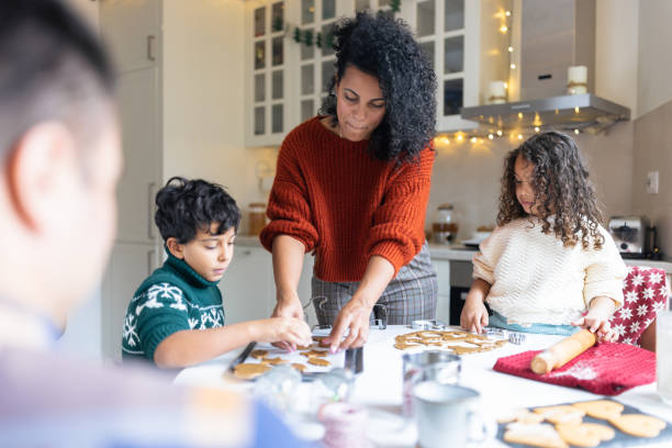 istock Family Baking Cookies Together in Cozy Kitchen 2156698032