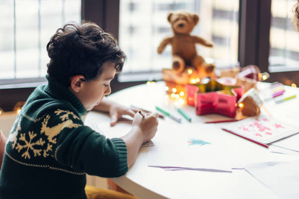 istock Child Drawing Christmas Cards Indoors 2156698085