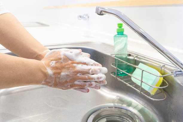 istock Women's hands washing hands in the kitchen 2156698274