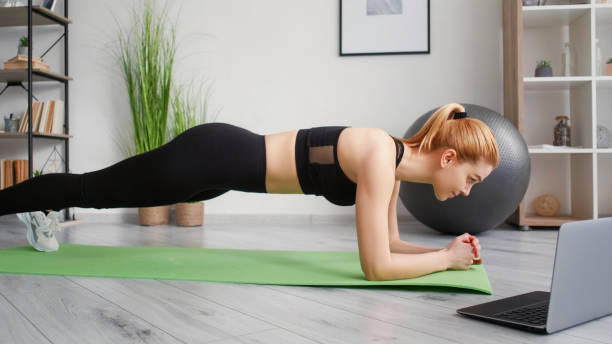 istock Online training morning workout fit woman plank 2156702224