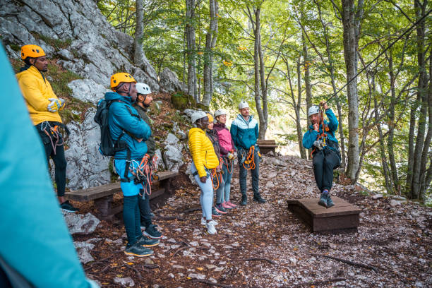 istock Diverse Group of Adventurers Getting Zip Line Instruction in Forest 2156703265