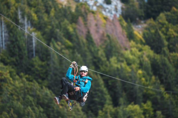 istock Energetic Male Zip Line Adventurer in Forest 2156703288