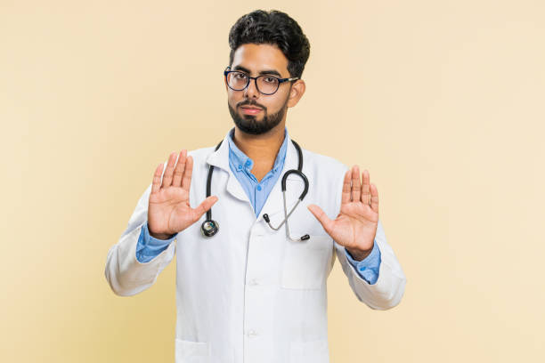 istock Strict doctor man warning hands gesture, saying no, be careful, advice to avoid danger, caution 2156703727